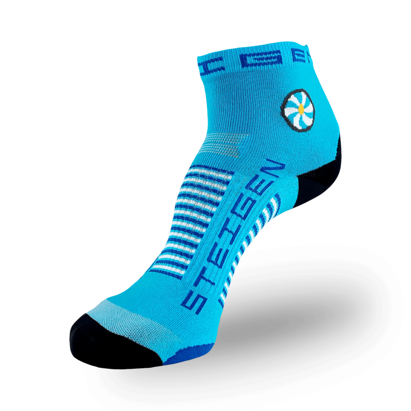 A Steigen brand quarter-length athletic sock on a transparent background. The sock is bright blue with a black toe and heel. It features a circular white and yellow flower-like graphic on the ankle. "STEIGEN" is printed vertically in navy blue on the top of the foot, with white and navy horizontal stripes across the arch.