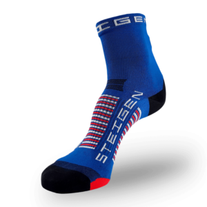 A bright blue athletic sock with a black toe and heel. It features navy, white, and red horizontal stripes across the arch and white vertical branding on the foot.