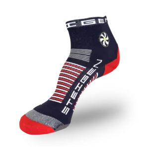 A navy blue athletic sock with a red toe and heel. The ankle features a circular white flower graphic and thick red/white horizontal stripes wrapping around the arch.