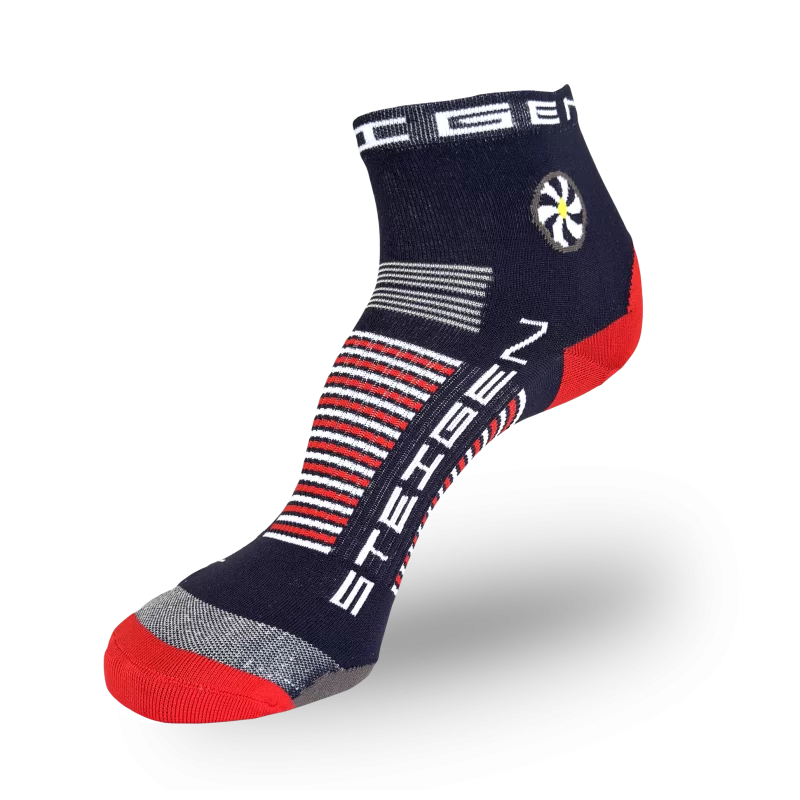 A navy blue athletic sock with a red toe and heel. The ankle features a circular white flower graphic and thick red/white horizontal stripes wrapping around the arch.
