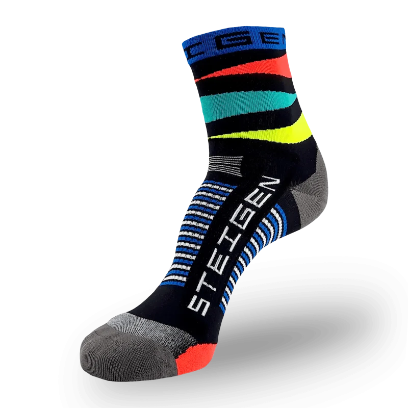 A black Steigen athletic sock with vibrant orange, teal, and yellow horizontal stripes around the ankle. It features a blue cuff, grey toe/heel sections, and white/blue stripes around the arch.