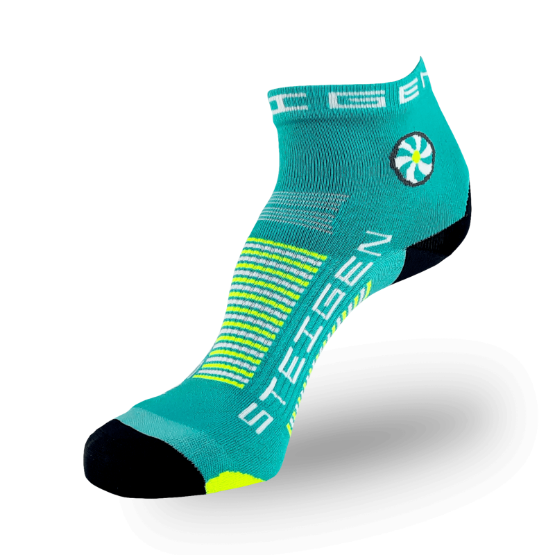 A teal-colored athletic sock with a black toe and heel. The ankle features a circular teal and white flower graphic with a yellow center. The brand name "STEIGEN" is printed in white on the foot with neon yellow and white stripes across the arch.