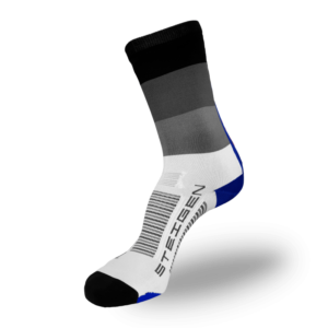 A white performance sock with a crew-length cuff featuring a gradient of black, dark grey, and light grey horizontal bands. It has a black toe, a blue heel, and grey arch stripes with black branding on the foot.