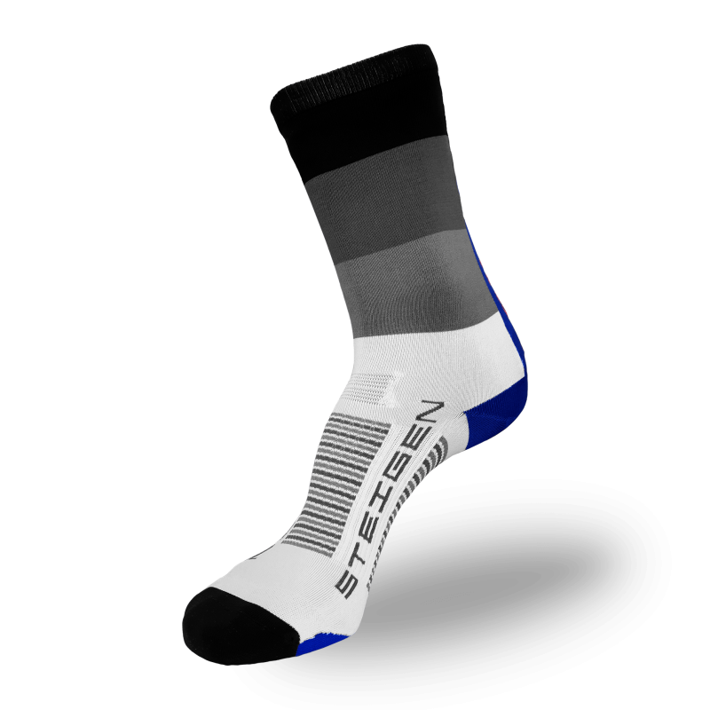 A white performance sock with a crew-length cuff featuring a gradient of black, dark grey, and light grey horizontal bands. It has a black toe, a blue heel, and grey arch stripes with black branding on the foot.