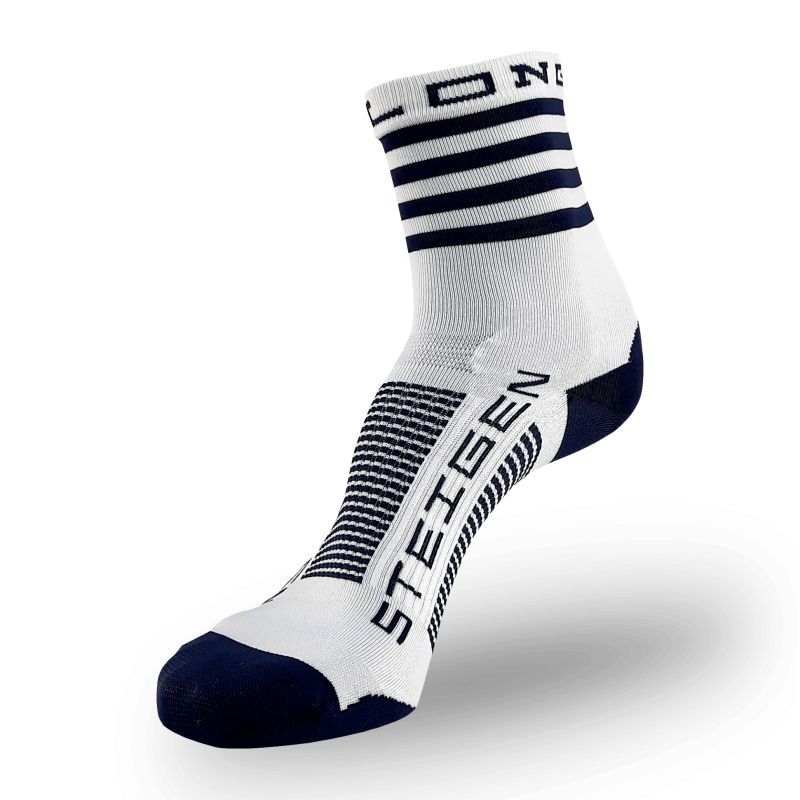 A white Steigen athletic sock with a navy blue toe and heel. The cuff features thick navy blue horizontal stripes. The word "STEIGEN" is printed vertically in navy on the top of the foot with navy and white stripes across the arch.